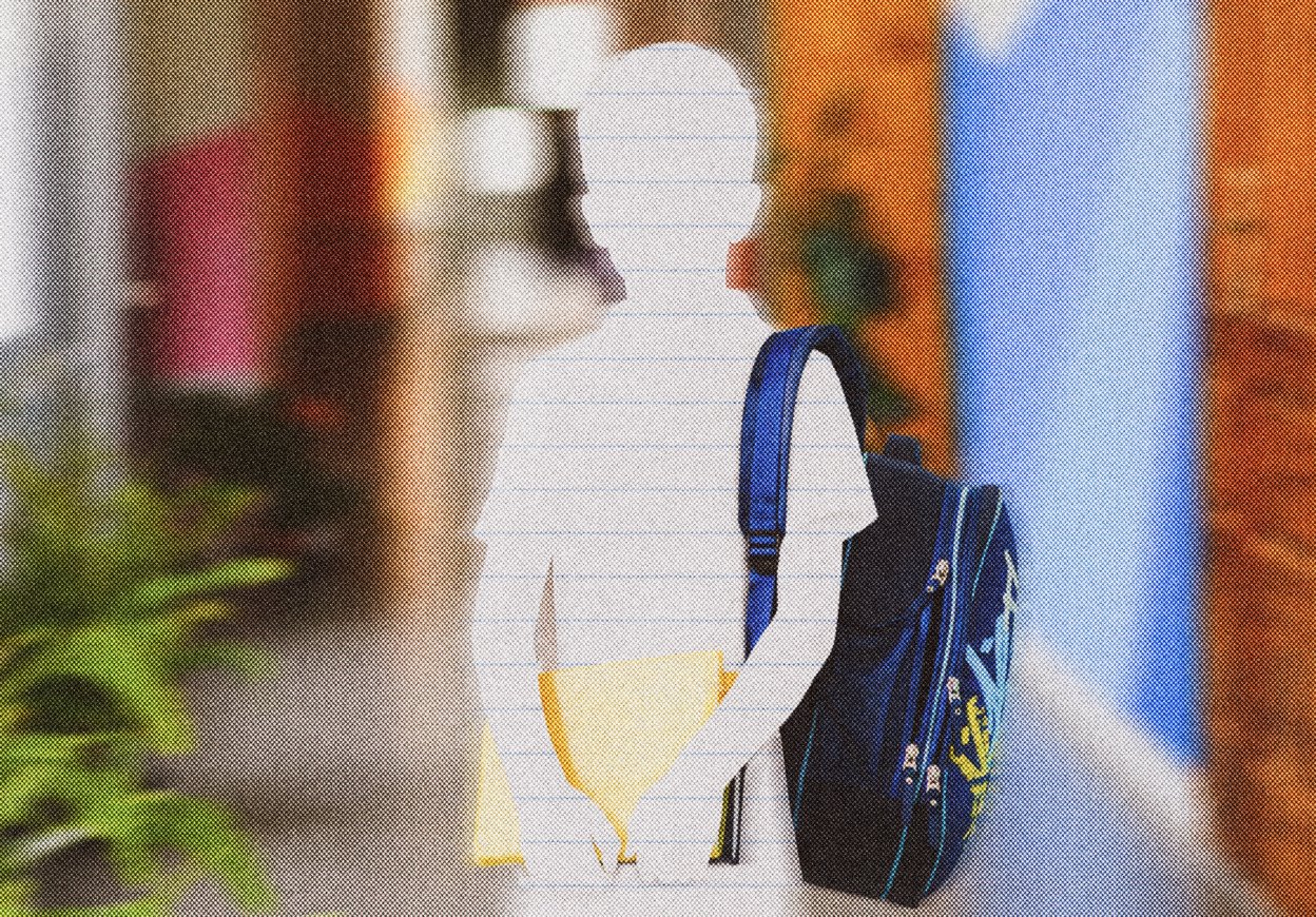 школьник стоит в коридоре